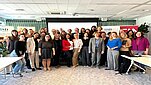 Photo with group of around 30 people in conference room