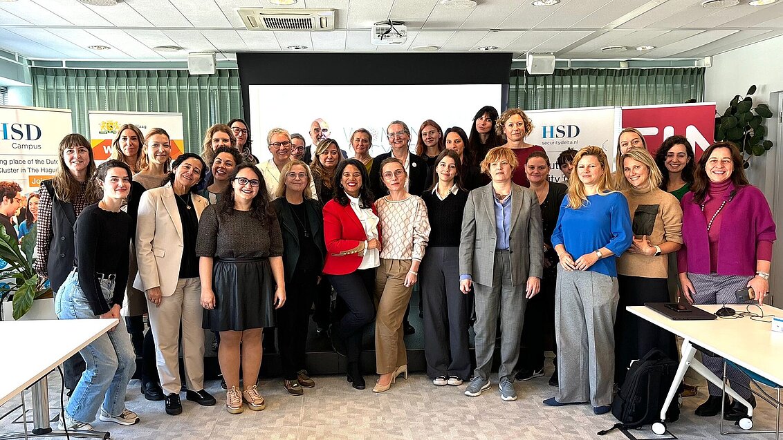 Photo with group of around 30 people in conference room