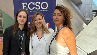 Three people standing in front of ECSO baner