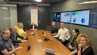  group of employees in meetings sitting at the table